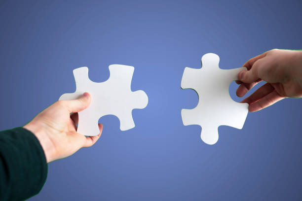istock human hands connect two puzzle pieces together, desicion making, sky background 1316181734