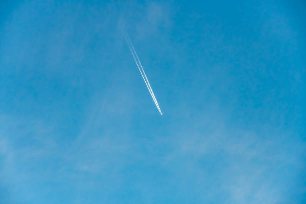 Contrails or vapor trails from an airplane in the blue sky over Sydney, NSW, Australia.