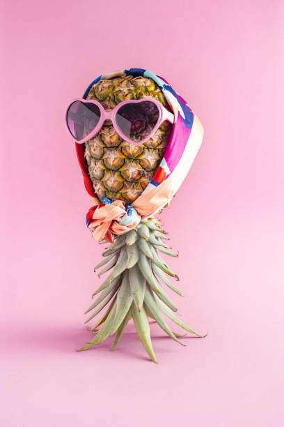 istock Creative summer idea with Pineapple hipster in sunglasses and scarf, stylish fruit. Minimal tropical concept. Art fashionable vacation concept. Summertime color mood, pineapple fruit 1316183047