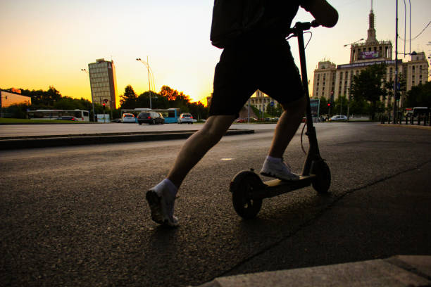 istock Low angle view of young man driving electric push scooter during sunset 1316189476