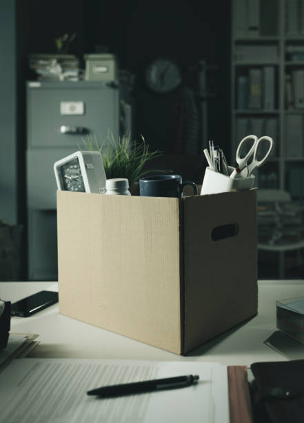 istock Office worker belongings in a cardboard box 1316193709