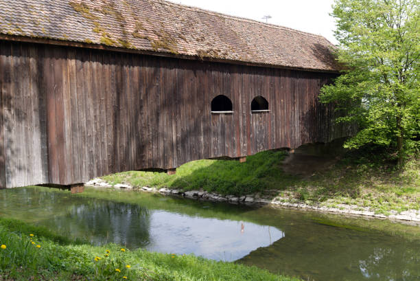 istock Old roofed wooden bridge over river Glatt at springtime. 1316195017