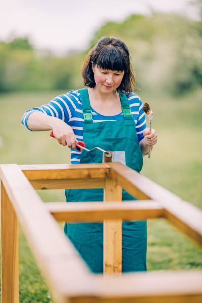 istock Woman painting garden bed 1316195991