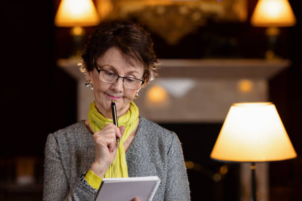 istock Woman with pen looking at her notepad 1316198752