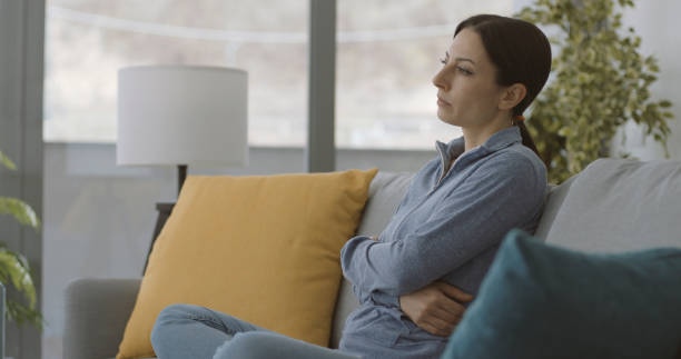 istock Exhausted lonely woman sitting on the couch 1316199655