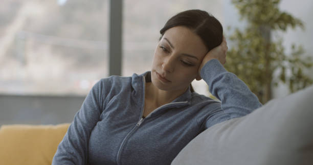 istock Exhausted lonely woman sitting on the couch 1316200455