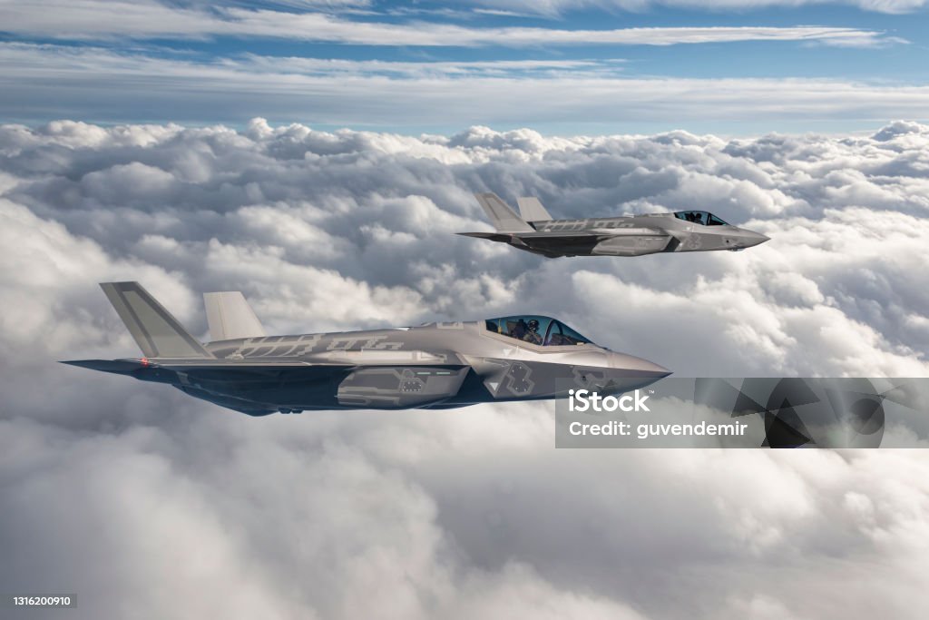 Two fighter jets flying over clouds Fighter Plane Stock Photo