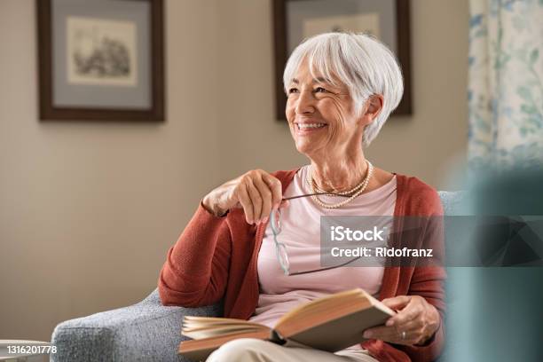 Happy Senior Woman Smiling At Home Stock Photo - Download Image Now - Senior Adult, Happiness, Senior Women