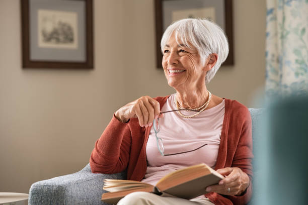 happy senior woman smiling at home - 70s imagens e fotografias de stock