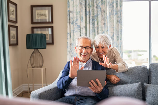 istock Happy senior couple doing video call at home 1316201830