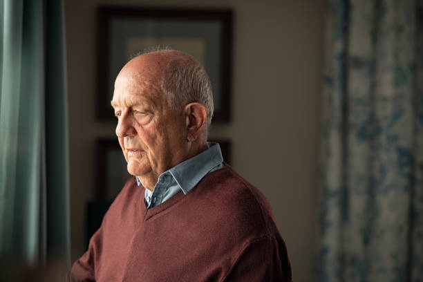 istock Upset senior man near window 1316201834