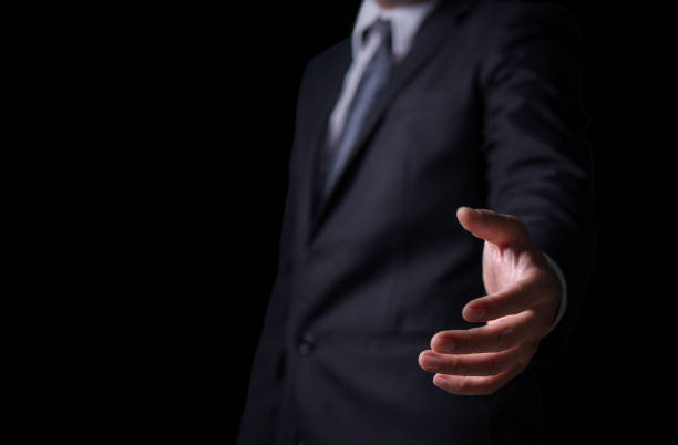istock Young man giving empty hand on black or isolated background, Businessman holding open hand, giving showing concept, copy space for text. 1316201901
