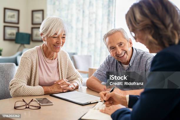 Senior Couple Consulting With Financial Agent Stock Photo - Download Image Now - Senior Adult, Financial Advisor, Advice