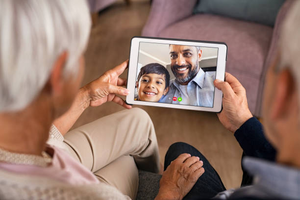 Family doing video call using digital tablet at home