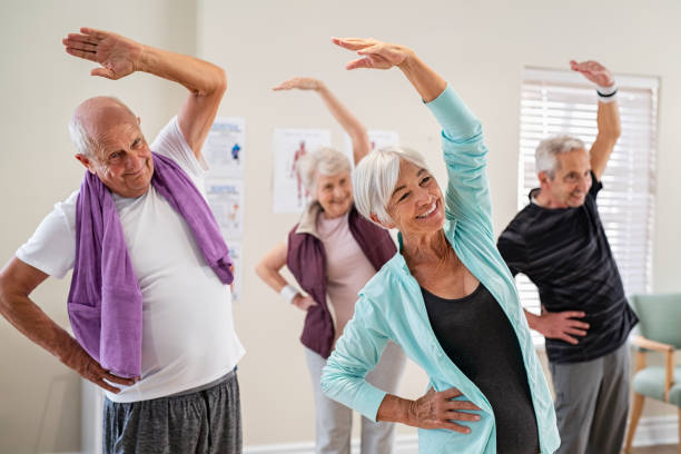 istock Senior people stretching at gym 1316202311