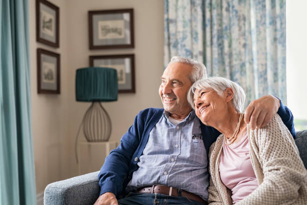 istock Loving senior couple embracing at home on sofa 1316202317