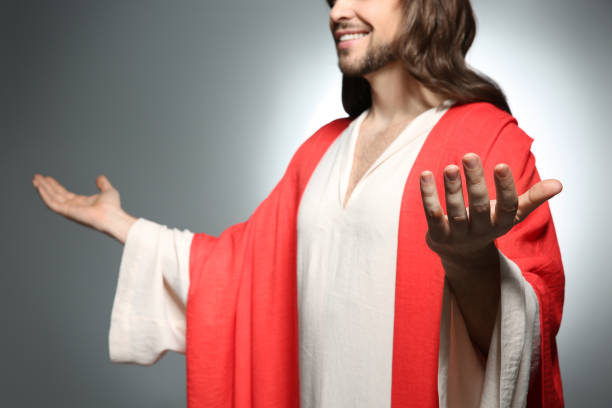 istock Jesus Christ reaching out his hands on grey background, closeup 1316204067