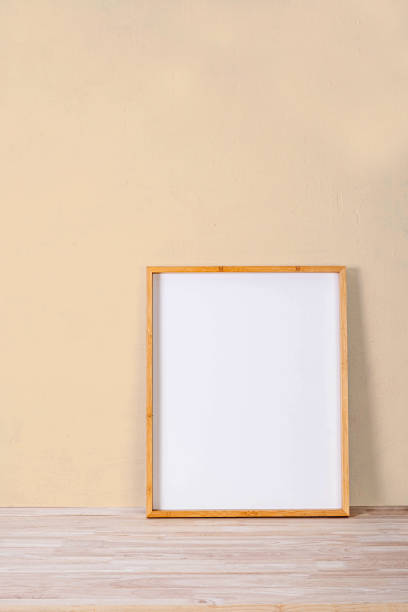 istock vertical wood frame mock up on wooden floor and Light brown background 1316208659