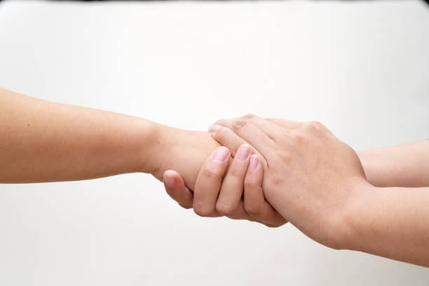 istock Two hands holding the other hand tightly, love, caring 1316208929