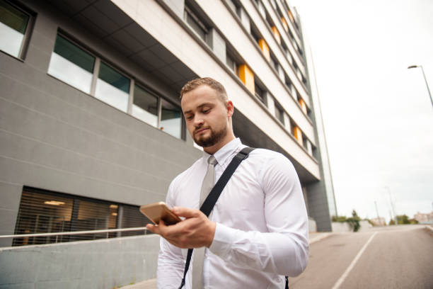 istock Young businessman using his phone outdoor 1316209471