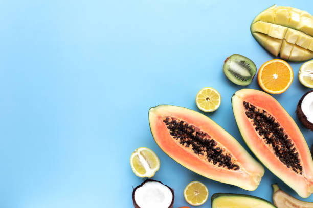 istock Different fresh tropical cut fruits on a blue background 1316210253