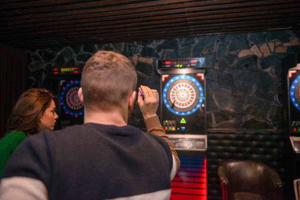 istock Couple are playing dart in a playroom 1316210342