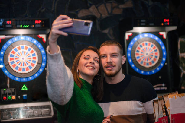 istock Couple are taking selfie in a dart room 1316210407