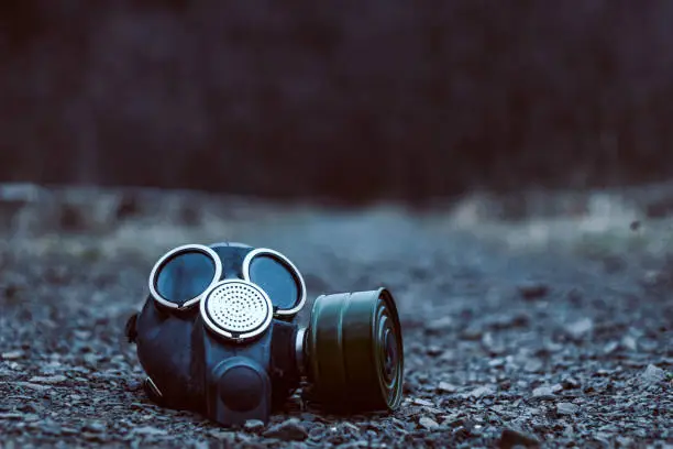 Photo of Closeup of the old gas mask lying at the ground