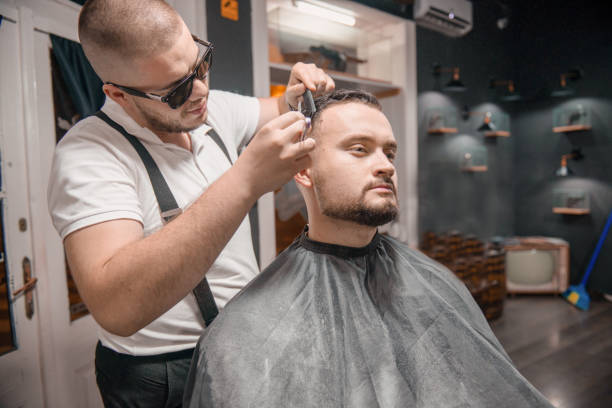 istock Barber is cutting hair 1316210986