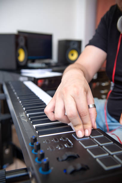 istock Man is playing piano in music studio 1316211935