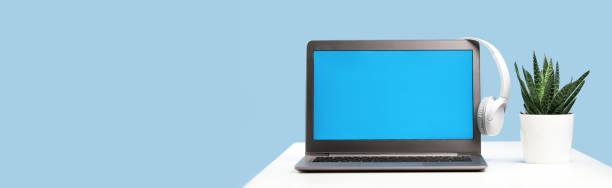 istock Laptop with wireless headphones on white desk 1316213461