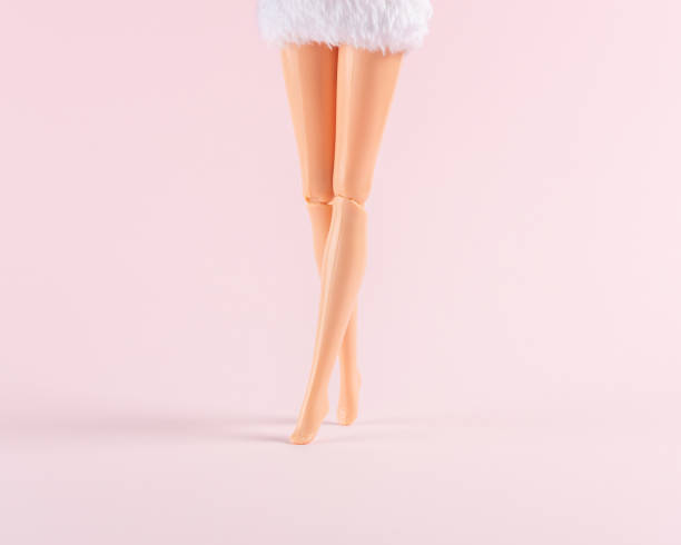 istock Girl doll legs on pastel pink background. Creative minimal concept. 1316213866
