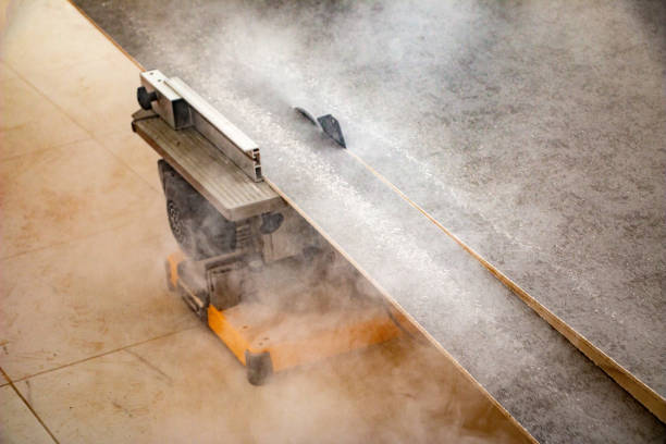 male hands of  construction worker sawing and cutting parts of  electric miter saw from  wooden board. wood board cutting process with blade rotation and dusty cloud electric miter saw male hands of a construction worker sawing and cutting parts of an electric miter saw from a wooden board. wood board cutting process with blade rotation and dusty cloud electric miter saw miter saw stock pictures, royalty-free photos & images