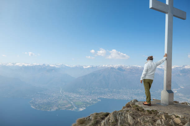 istock Hiker male contemplates view from mountain top 1316215869