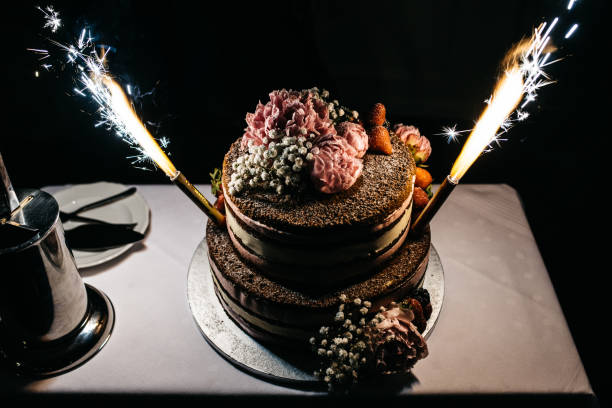 istock Beautiful chocolate cake with peonies and gypsophila and table firework 1316215887