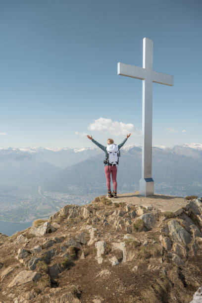 istock Hiker female stands arms out on mountain top 1316215889