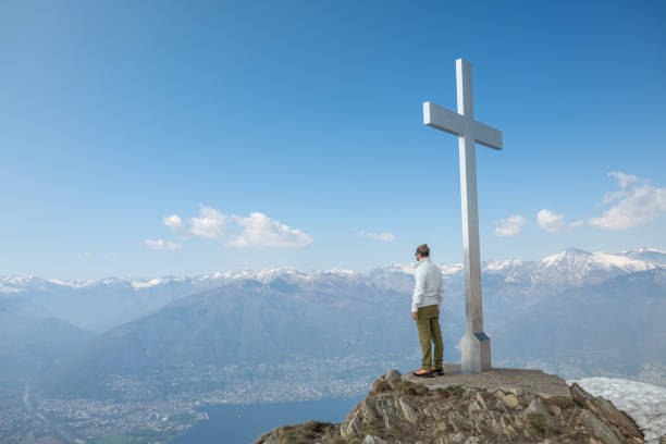 istock Hiker male contemplates view from mountain top 1316215921