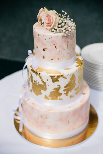 Elegant wedding cake with golden and rose details