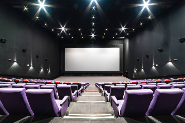 istock Empty big movie theater hall with a white screen for copy space 1316217943