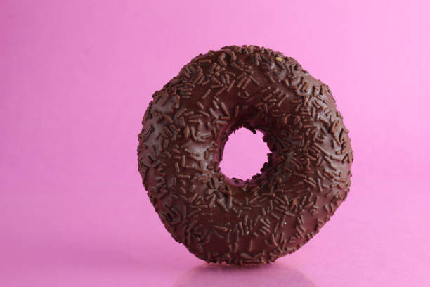 istock Chocolate berliner doughnut on a pink background with a place to text a copyspace breakfast dessert national dish 1316218058