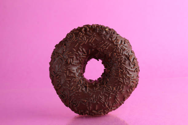 istock Chocolate berliner doughnut on a pink background with a place to text a copyspace breakfast dessert national dish 1316218665
