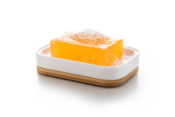 Soap bar with suds isolated on white