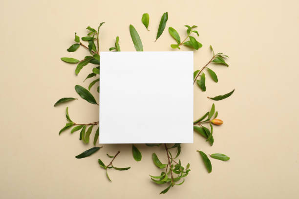 istock Flat lay composition with pomegranate branches and blank card on beige background. Space for text 1316219331