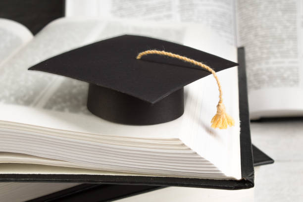 istock Open book on wooden deck table and black board background. Back to School. Education concept with copy space for your ad text. 1316220868