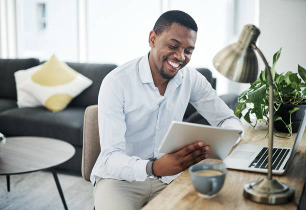 istock Shot of a handsome young businessman sitting alone and using technology to work from home 1316220902