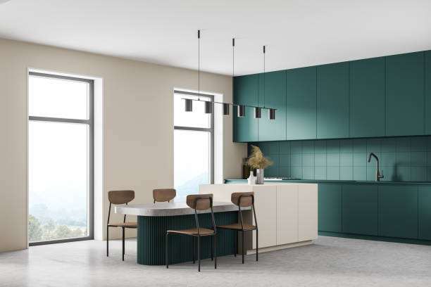 istock White and ocean green modern kitchen interior near window. Dining area with table. Concrete floor. Tall window. 1316221140