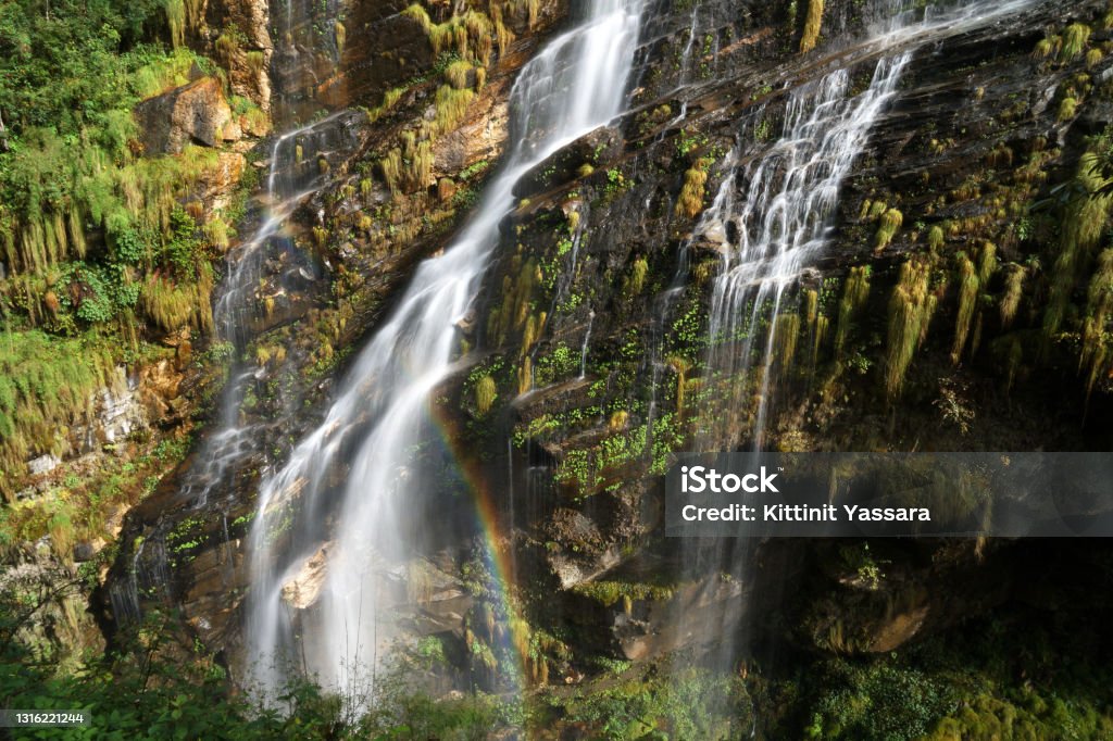 Beautiful waterfall on the way trekking to Annapurna base camp - green natural scene at annapurna national park Nepal Annapurna Circuit Stock Photo