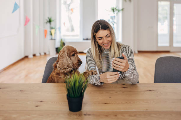 istock Woman with dog using phone 1316221259