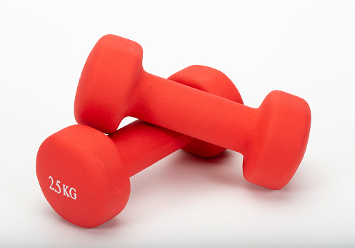 Two red rubber or plastic coated fitness dumbbells isolated on white background