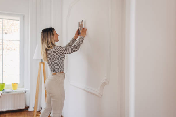 istock Decorating her wall with photograph 1316222393